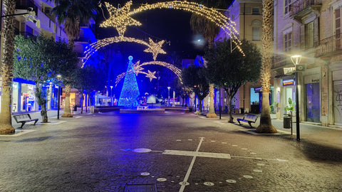 Decorative Christmas arch with lights on a street at night